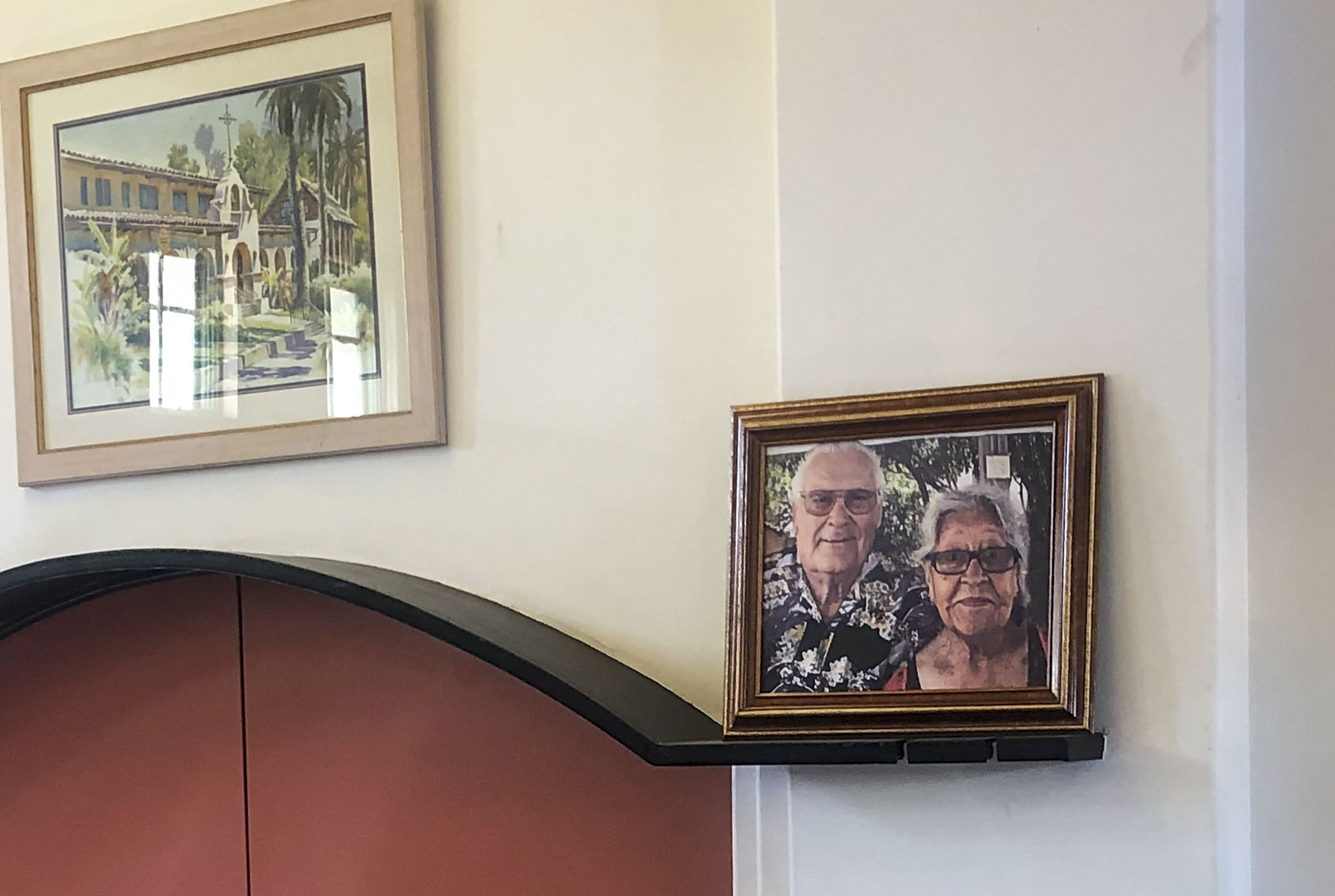 A photo of Ruben Lozano Nava and Lorraine Rose Nava hangs on the wall in the Grapevine Room at the San Gabriel Mission.
